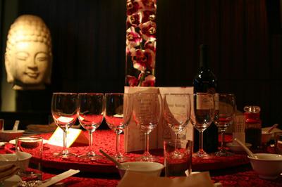 Dramatic red and black centerpiece with Orchids in a cylinder vase