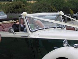 bride and groom kissing in car